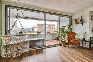 Modern room with a large balcony behind a glass door